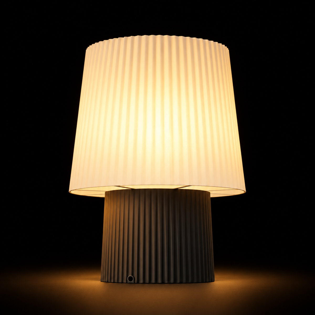 Pleat Table lamp — lights on — studio